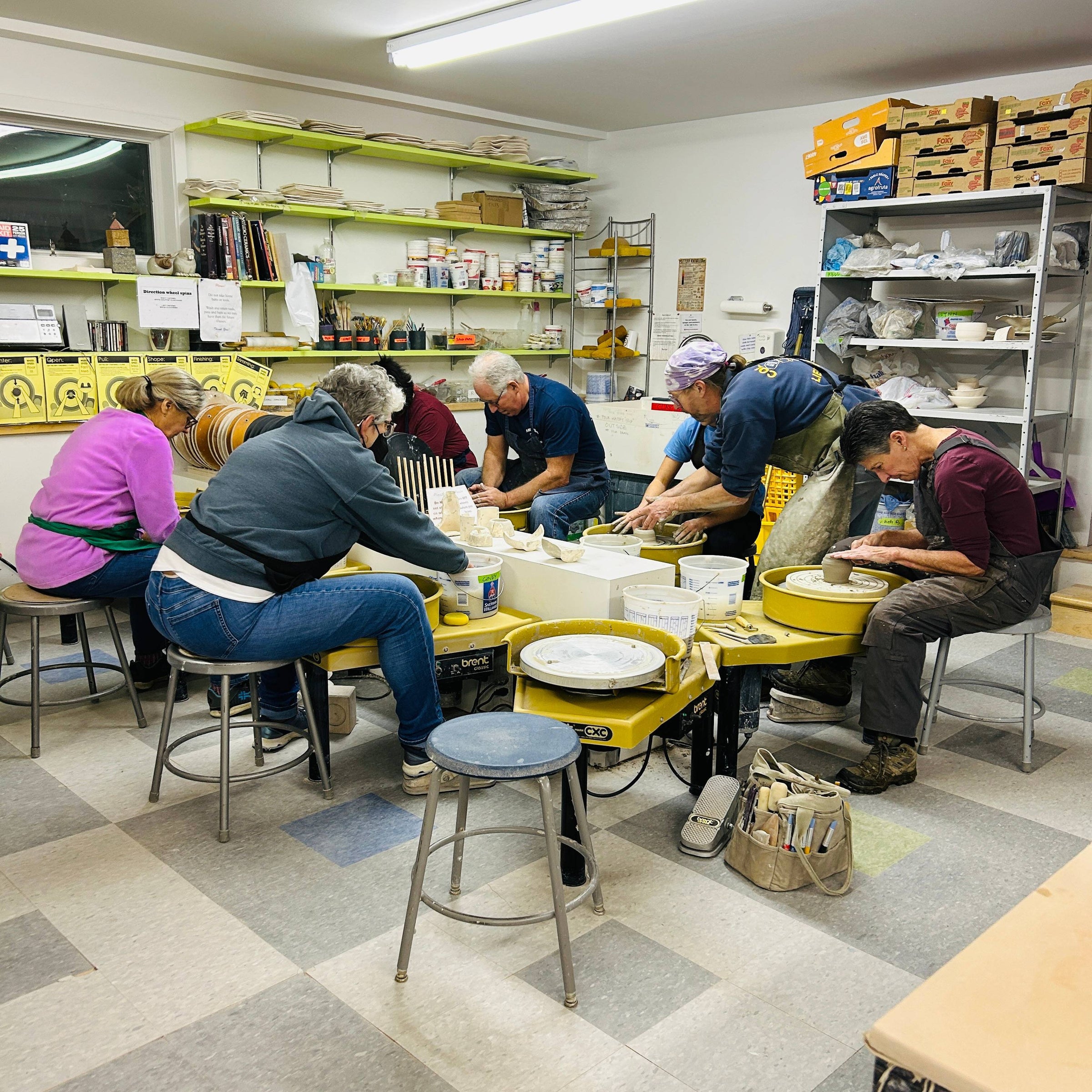 A group of potters at the wheel in our beginner class.
